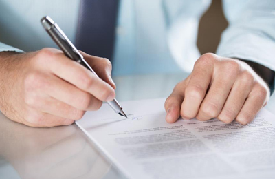 man signing legal documents 