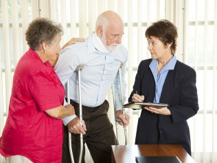 man on crutches with wife and lawyer